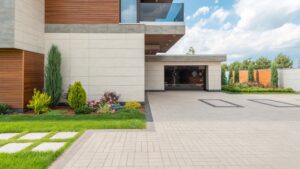 a modern house with a concrete driveway and landscaping.