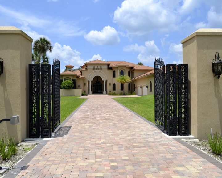 a mansion with wrought iron gates located in the city.