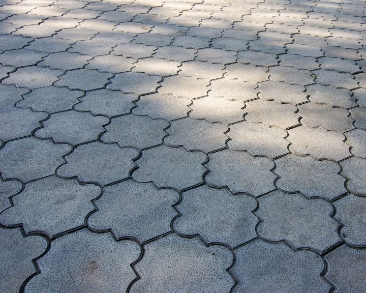A concrete walkway with a pattern of bricks in the city.