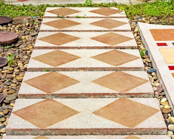 A city walkway with a red and brown pattern.